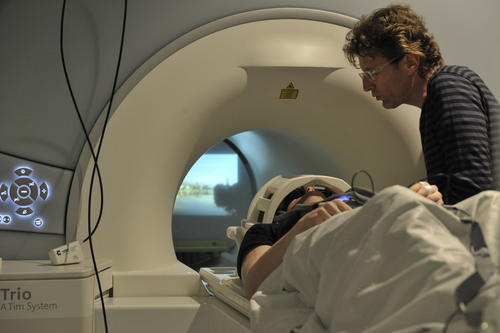 A test subject is moved into the “tube” of the MRI unit. The functional images of his brain will later be analyzed using statistical methods.
