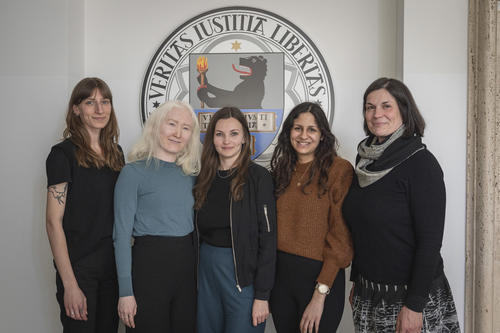 Die fünf Mitarbeiterinnen der Stabsstelle Diversity stehen vor dem Siegel der Freien Universität Berlin