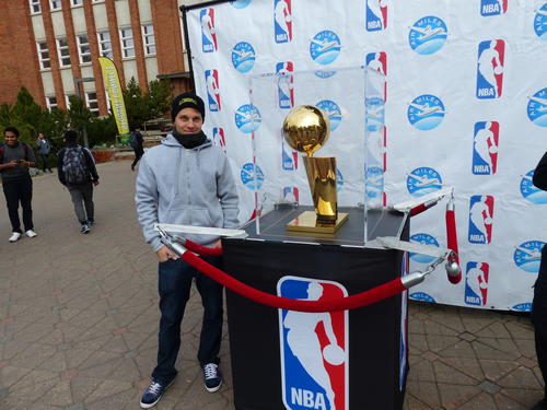 Robert Brundage next to the original NBA trophy, which was on display one day on the campus in Edmonton.