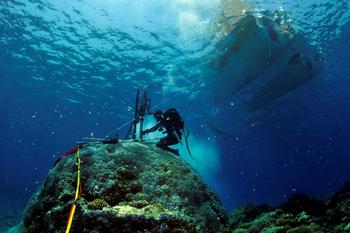 Scientists drilling coral on the Rowley Shoals, a group of three coral reefs protruding from the water similar to atoll coral reefs off the northwestern coast of Australia.