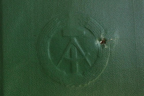 Fred Woitke’s social insurance booklet, showing a bullet hole.
