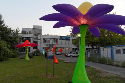 Die blumenförmigen Leuchtobjekte in den Außenbereichen der Universität.