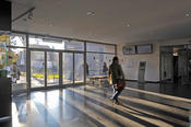 The main entrance of the School of Business and Economics is flooded with light.