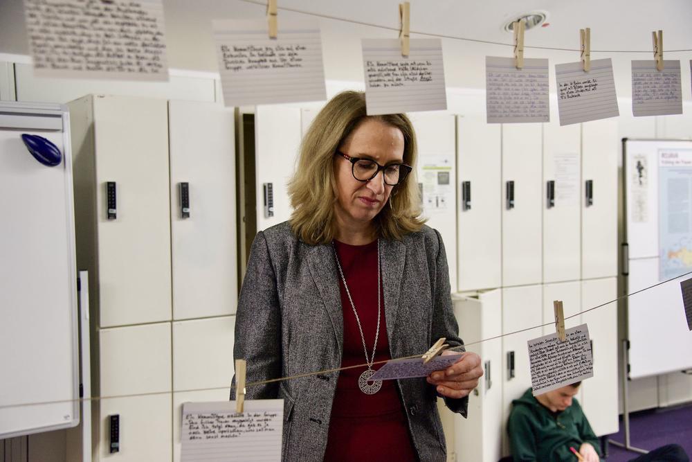 Heike Pantelmann, the managing director of the Margherita von Brentano Center, reads examples from an installation that prompts visitors to write down their own experiences of sexual harassment and violence.