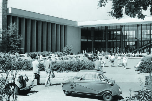 For several years, the space adjacent to the auditorium and the lobby was used as a parking lot. The vehicle in the foreground of this picture from the 1950s is a Messerschmitt cabin scooter.