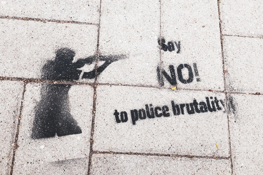 “Say NO! to police brutality”: Graffiti on campus and in the city.