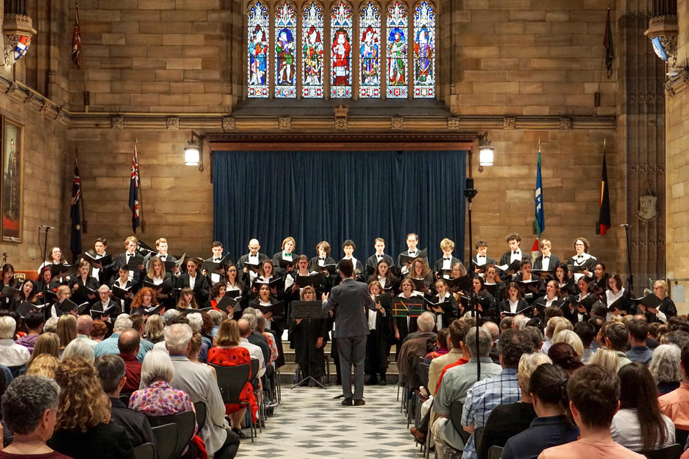 The Sydney University Musical Society’s Christmas concert was held in the Great Hall of the university, an example of Gothic revival architecture.