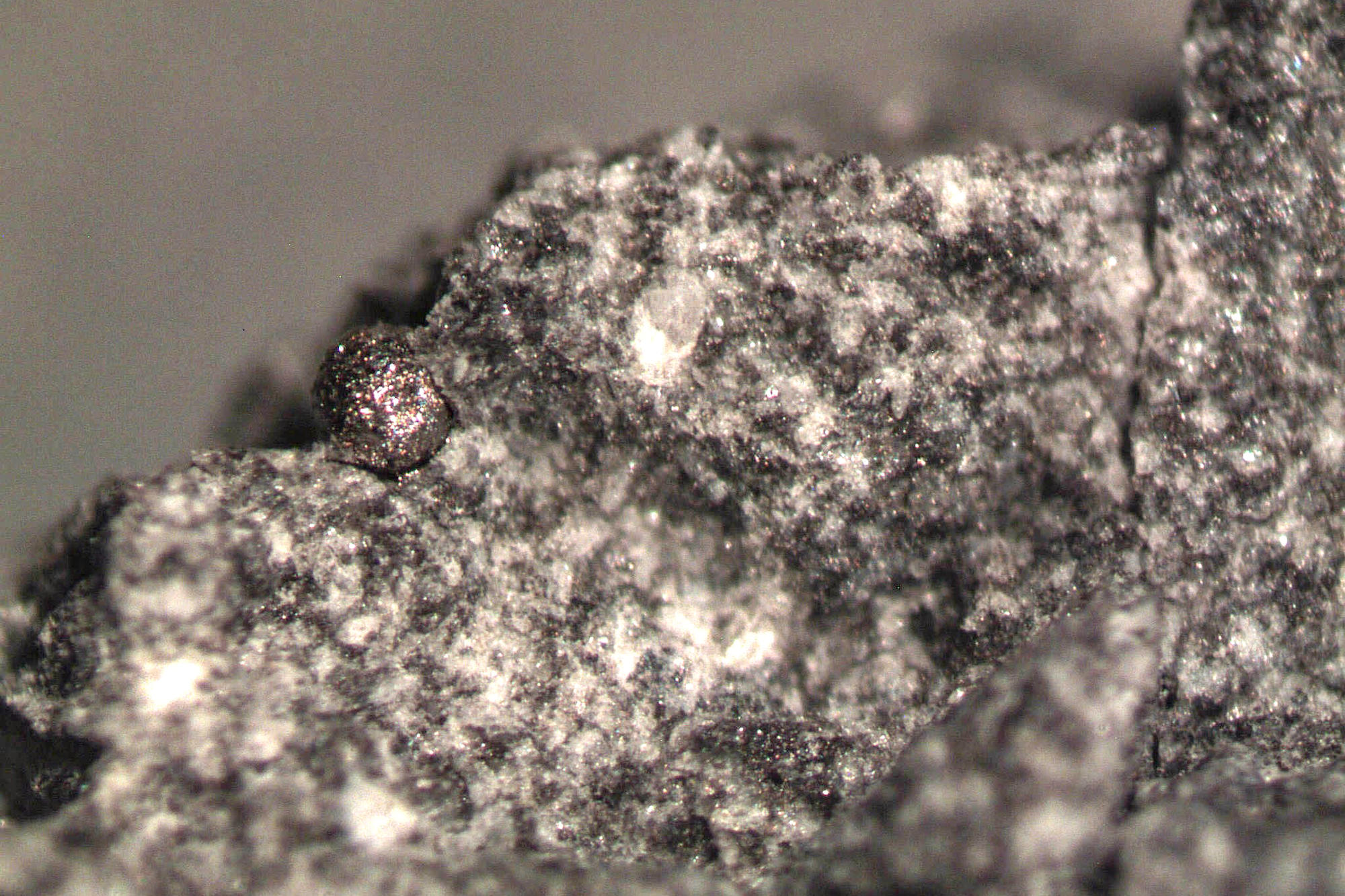 The tiny ball of ferrous metal that researchers from Freie Universität laid bare from within the moon rock debunks theories that the moon landing was a hoax.