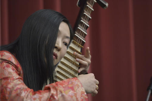 Music from Japan, South Korea, and China accompanied the ceremony. Here Jingyu Zhang is shown playing the pipa, a traditional Chinese lute.