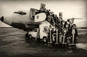 Students from Freie Universität Berlin are often hired through the university's agency for temporary employment, Heinzelmännchen, to work as Santa Claus. Here a group of them is deboarding an airplane in Berlin's traditional airport, Tempelhof.