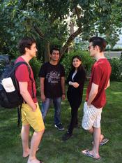 A chat under the plum tree in the International House's garden during an event of the International Club of Freie Universität.