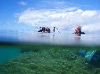Dr. Jens Zinke (at right) and a colleague drilling coral in Madagascar.
