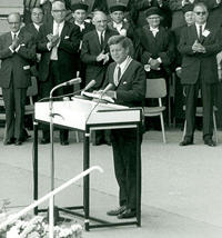 John F. Kennedy giving a speech in front of the Henry Ford Building on June 23, 1963