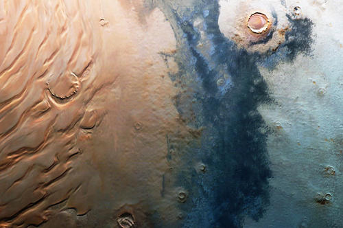 Vielfältige Marslandschaft: Auf der linken Seite des Bildes zeigt sich eine zerfurchte sandfarbene Fläche. Am rechten Bildrand sind Ausläufer der Nordpol-Eiskappe zu sehen.